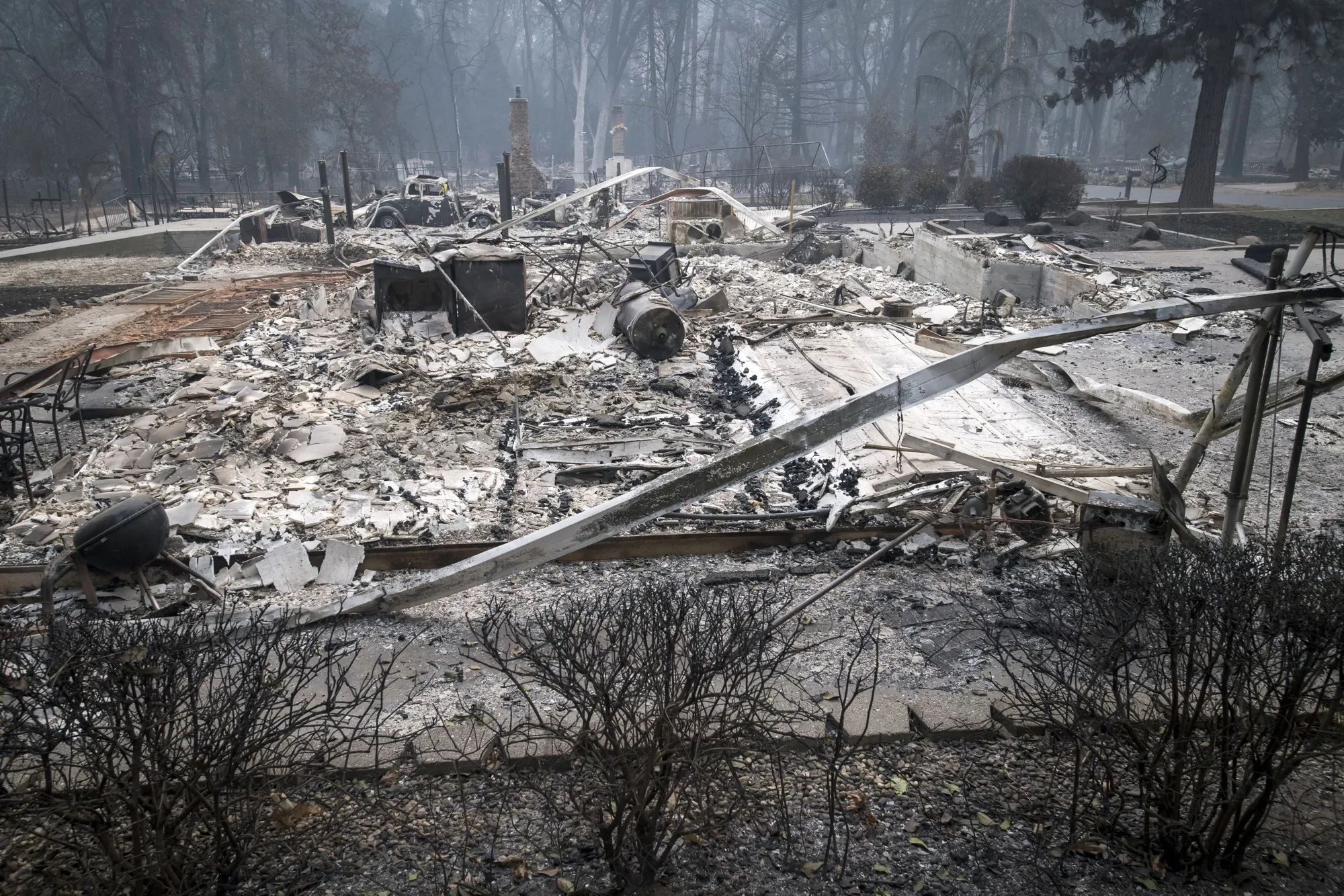 Burned-out homes and a vehicle stands in Paradise, California, U.S., on Thursday, Nov. 15, 2018.