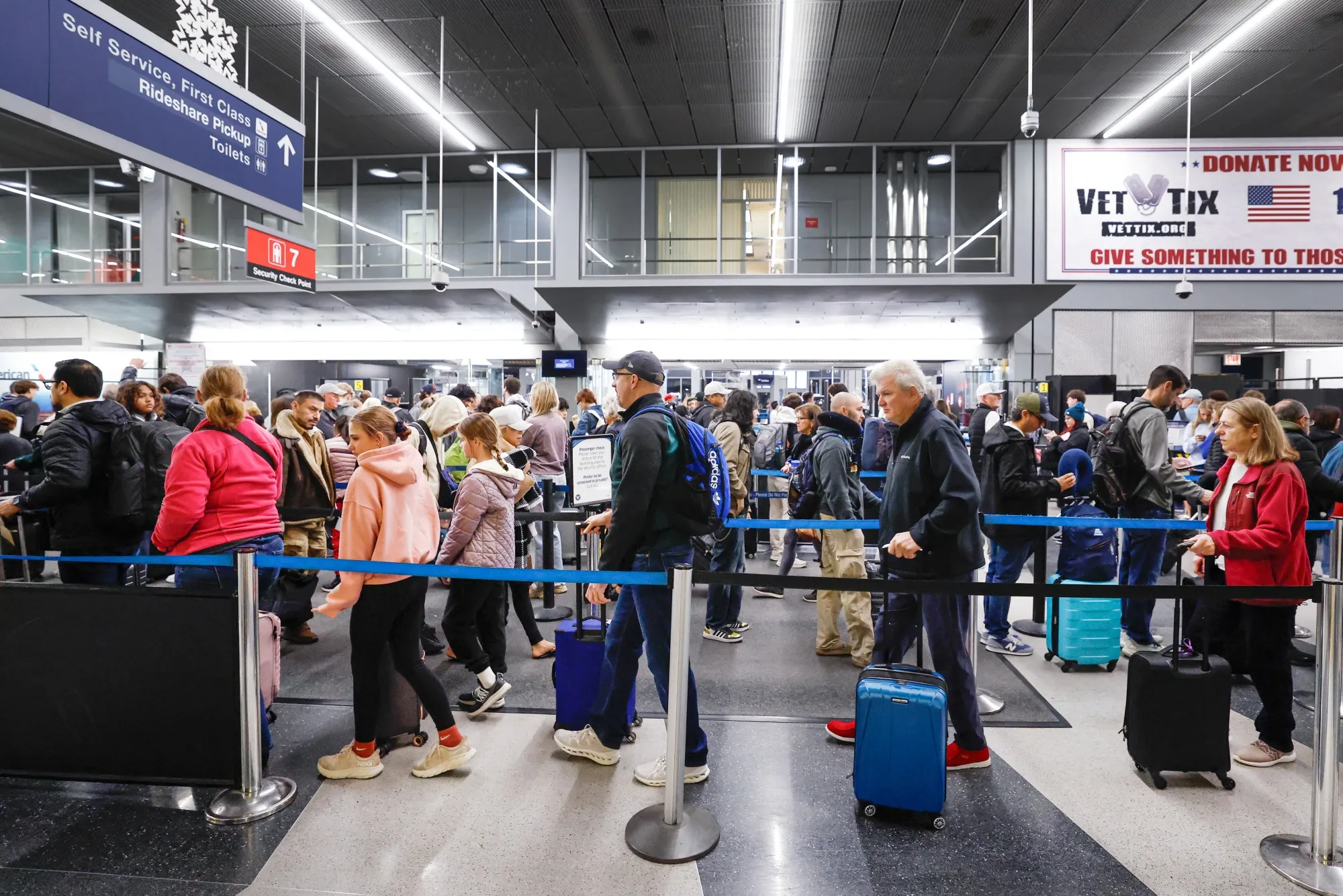 Travelers wait in line at a security checkpoint at O'Hare International Airport in Chicago on Nov. 25.