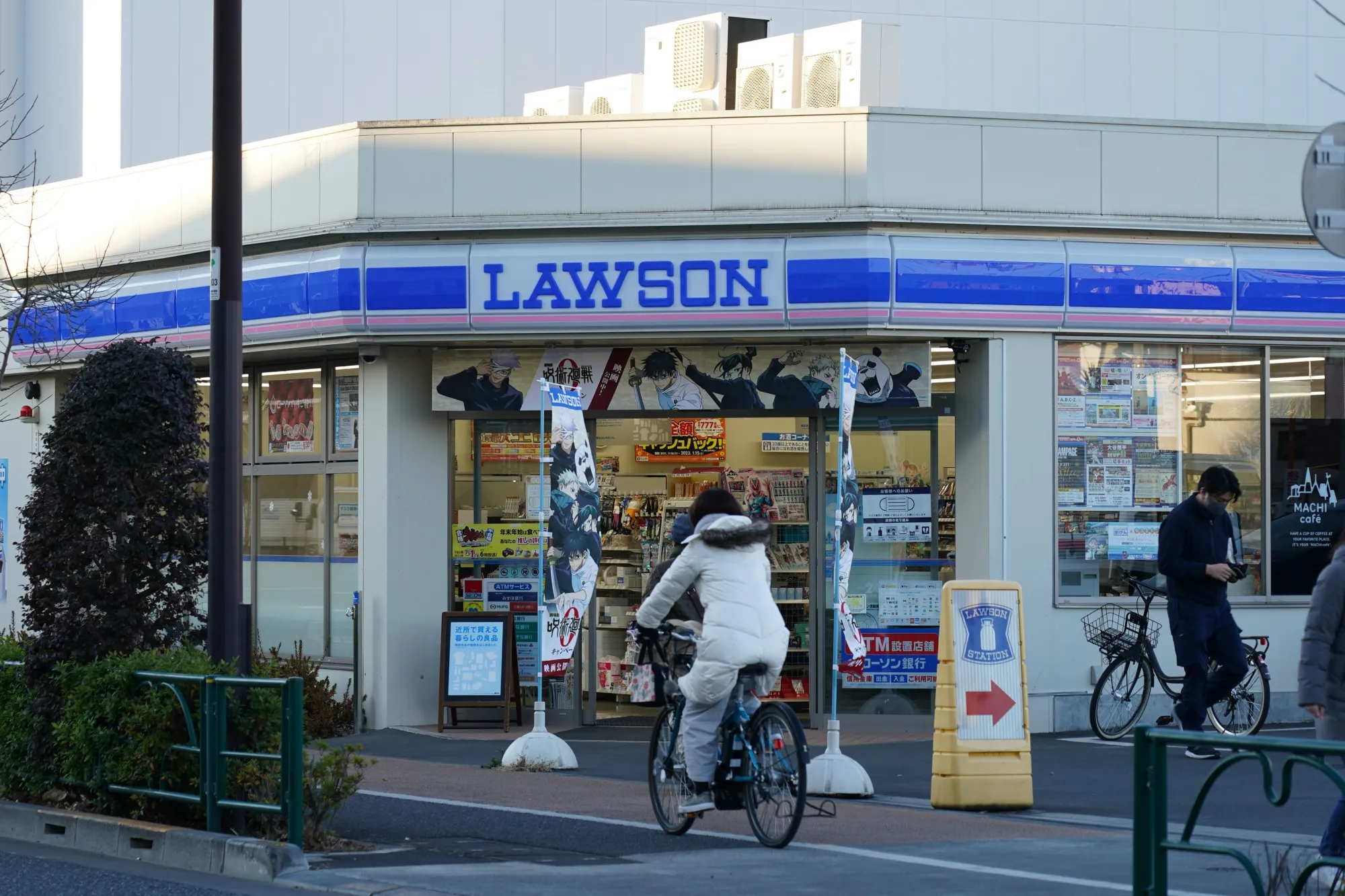 A cyclist travels past a Lawson Inc. convenient store in Tokyo.