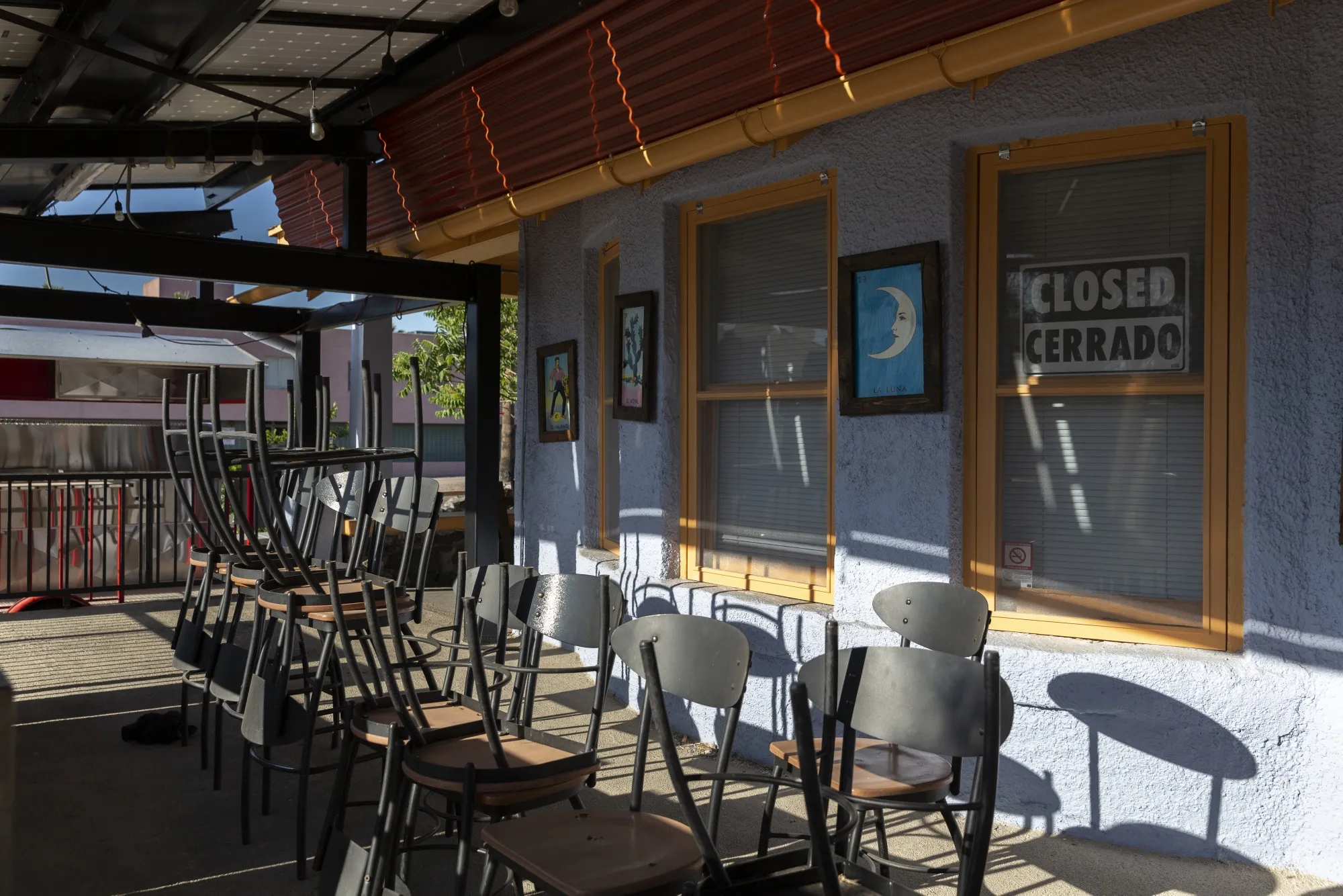 Chairs are stacked outside a restaurant which remains temporarily closed in Tucson, Arizona, U.S., on Monday, May 11, 2020. Restaurants and coffee shops can start offering dine-in service while limiting occupancy and checking employees for Covid-19 symptoms before their shifts, Azcentral reported.