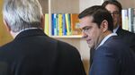 Greece's Prime Minister Alexis Tsipras, right, is welcomed by European Commission President Jean-Claude Juncker, left, ahead of a meeting on Greece, at the European Commission in Brussels, on June 24, 2015, as eurozone finance ministers try to finalise a debt deal and avoid a default by Athens.
