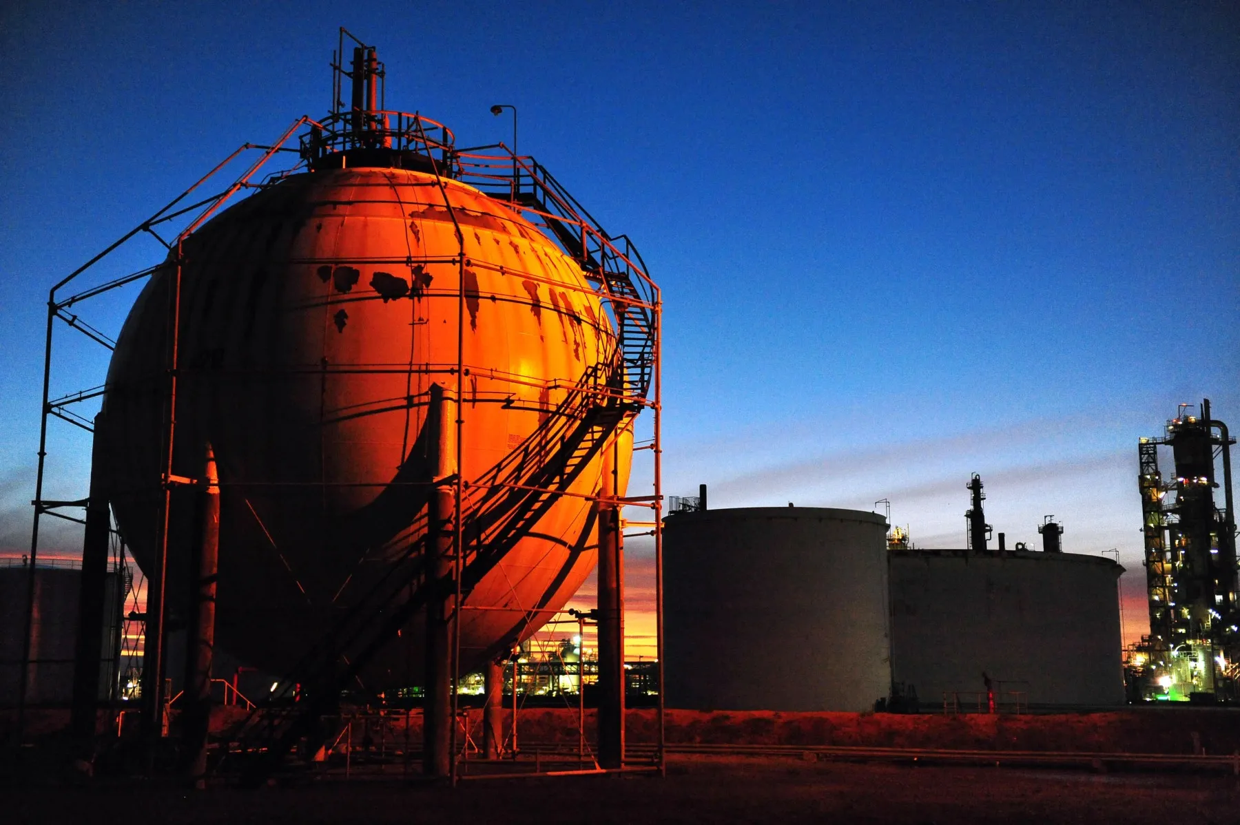 The sun sets on the butane storage spheres at a Caltex Australia refinery in Brisbane, Australia.