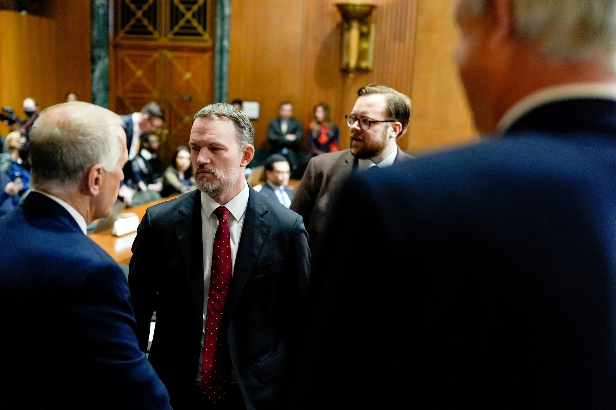 Jamieson Greer speaks to Thom Tillis while arriving for a Senate Finance Committee hearing in Washington, DC, on April 8.