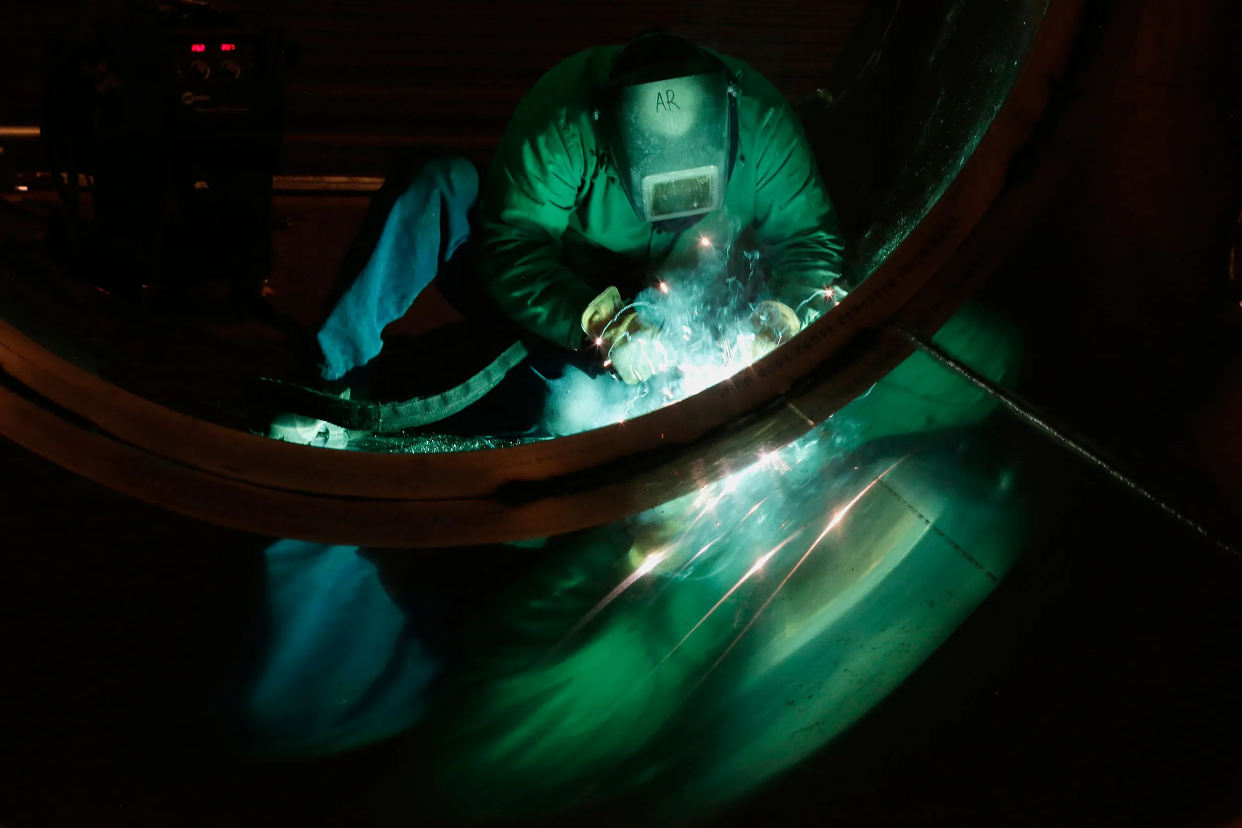An employee welds the tank of a trailer in Portland, Oregon.
