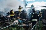 Firefighters work at the scene of a Russian missile strike, in Bakhmut, Ukraine, on July 19.
