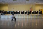 An election official sits in a chair while waiting for voters to arrive at a polling station in Miami, Florida, on March 17.