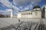 People walk across nearly empty Cathedral Square in Vilnius, Lithuania on April 3.