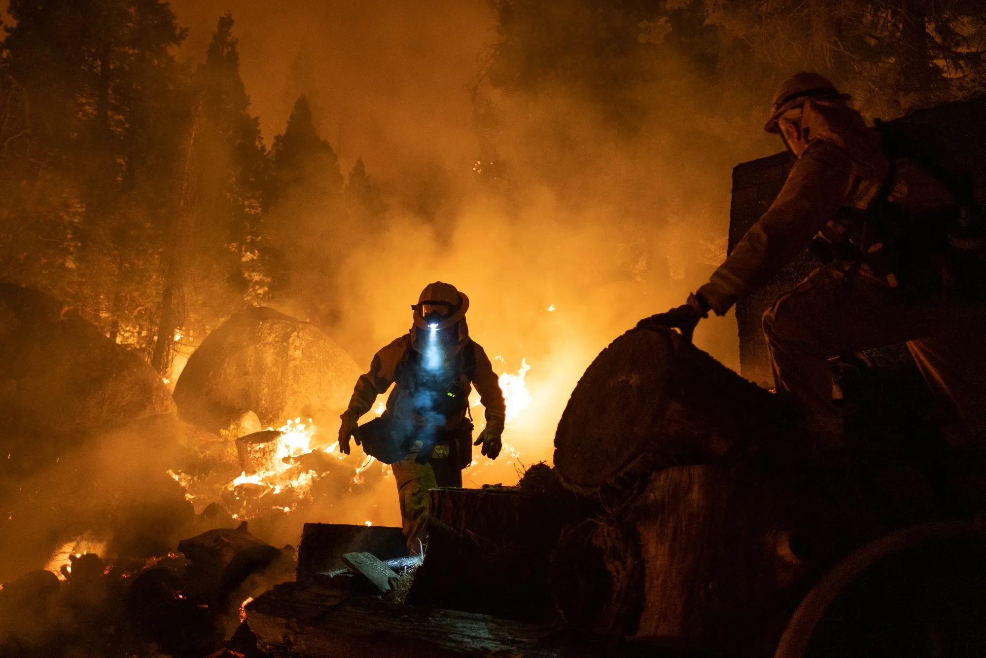 Firefighters attempt to protect a home during the Caldor Fire near Meyers, Calif., on&nbsp;Aug. 31.