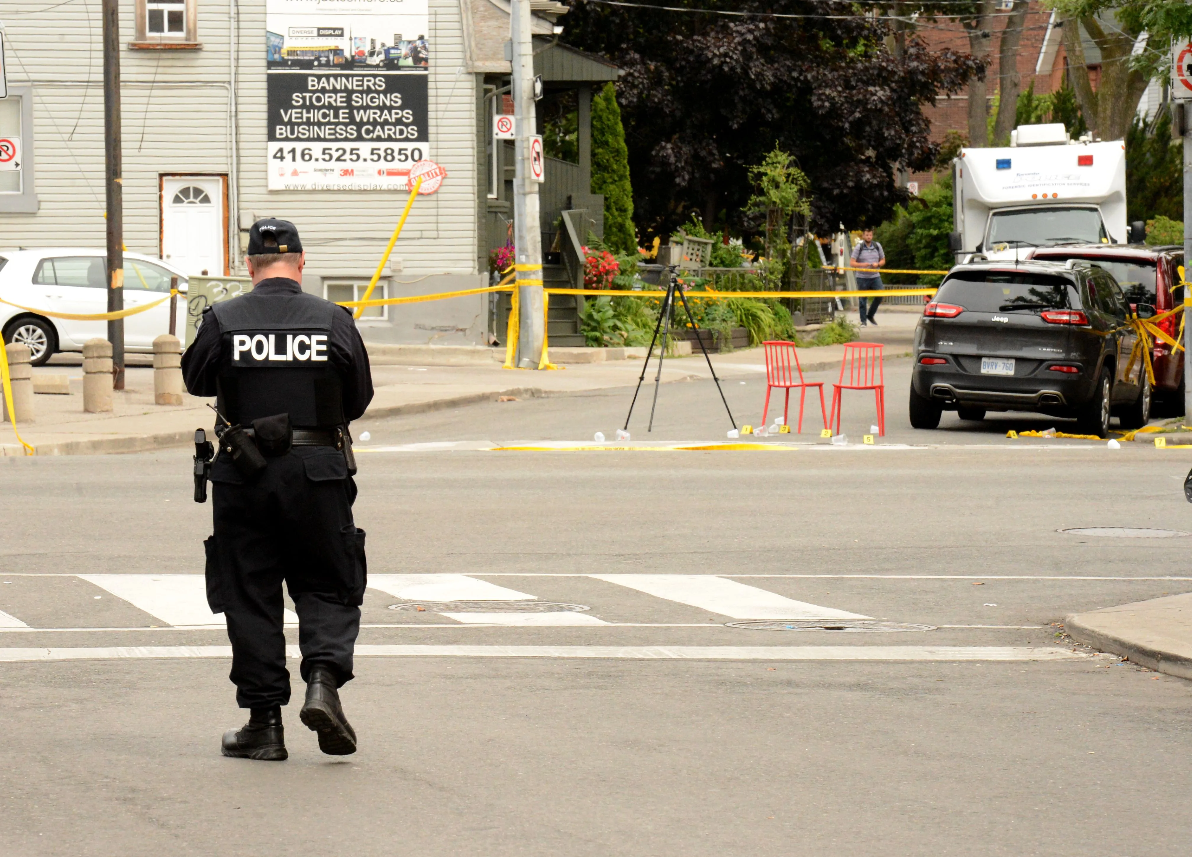Toronto Police investigate the scene of a shooting the night before in Toronto.