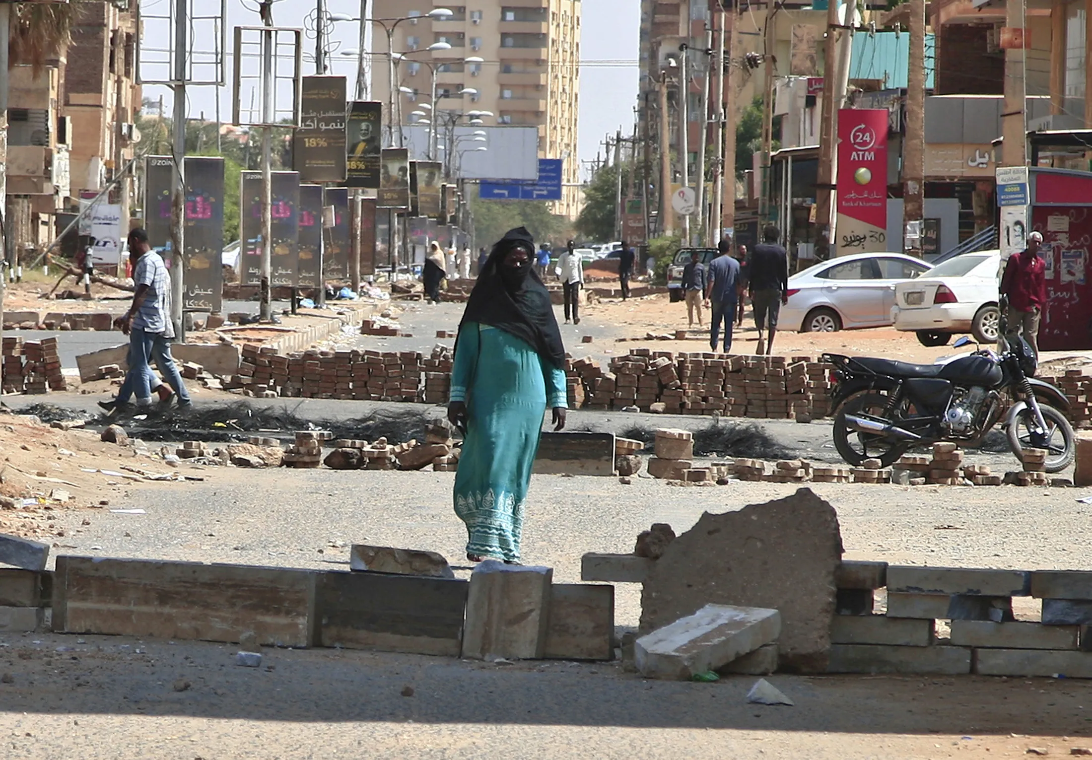 Sudanese anti-coup protesters use bricks to barricade a street in the capital Khartoum on Oct. 27, 2021.