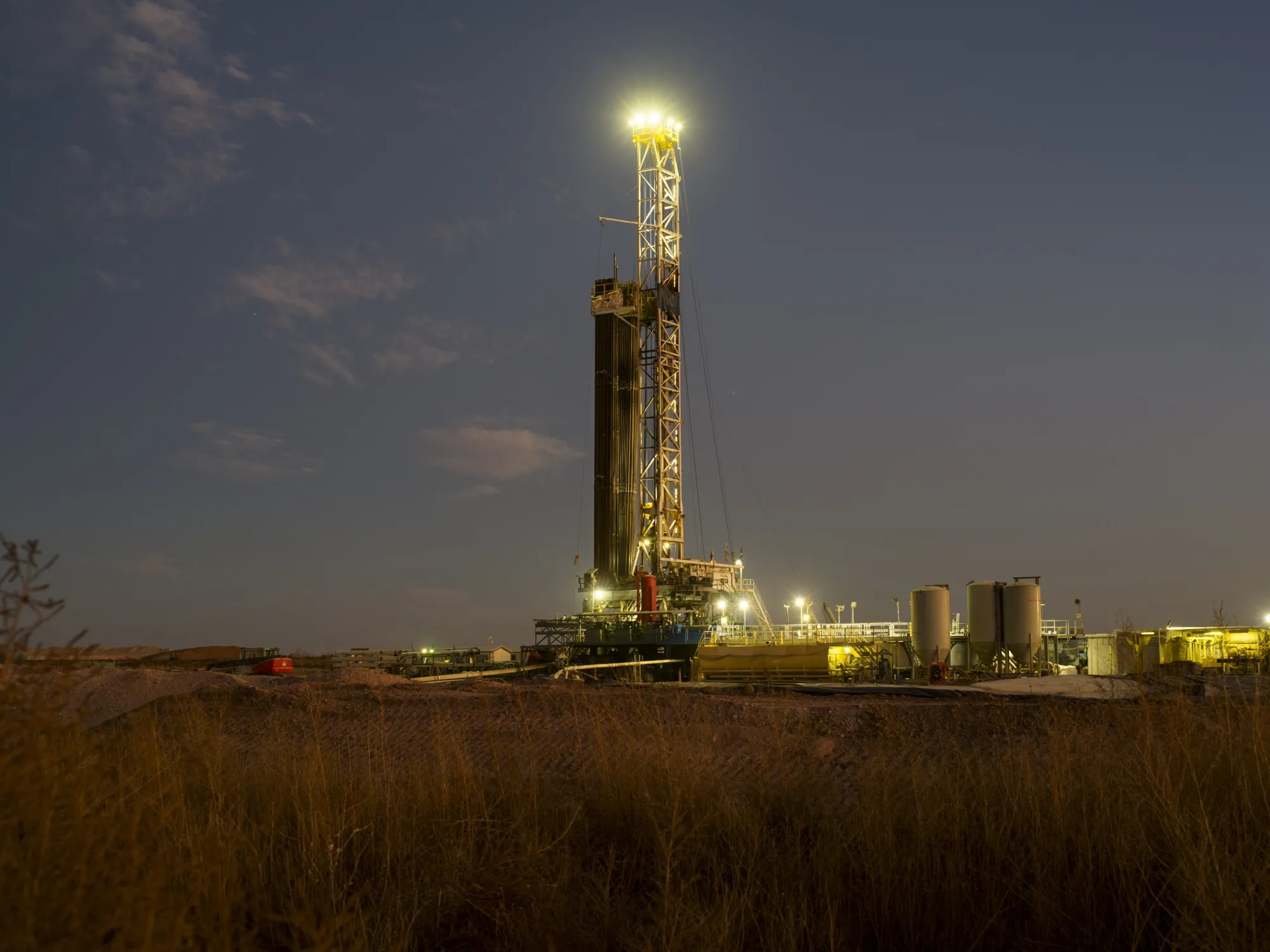 An oil drilling rig operates near Midland, Texas.
