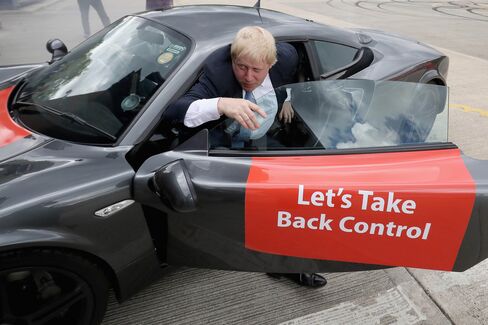Boris Johnson emerges from a sports car after it performed 'donuts' during a visit to Ginetta Sports cars as part of the Brexit Battle Bus tour in Yorkshire this week.