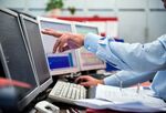 A financial trader points to data