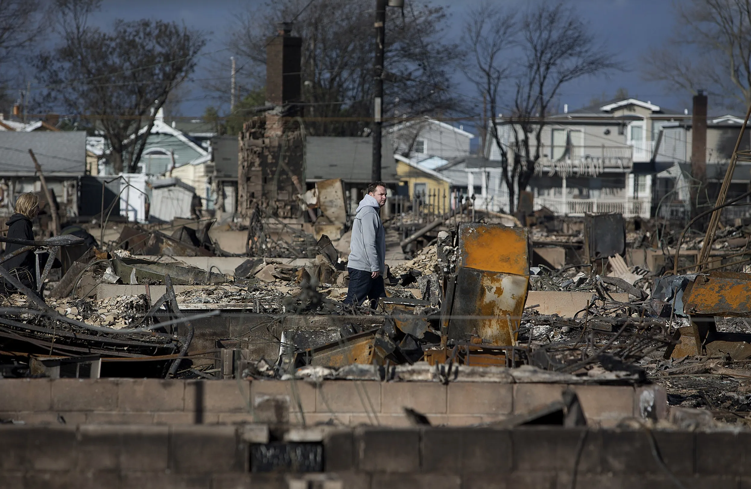 A resident looks over damage in the Breezy Point neighborhood of the Queens borough of New York, in October 2012.