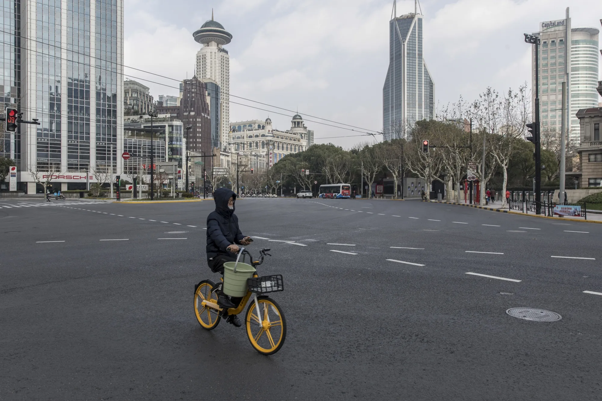 A man rides a bike through an almost empty Nanjing Road in Shanghai.