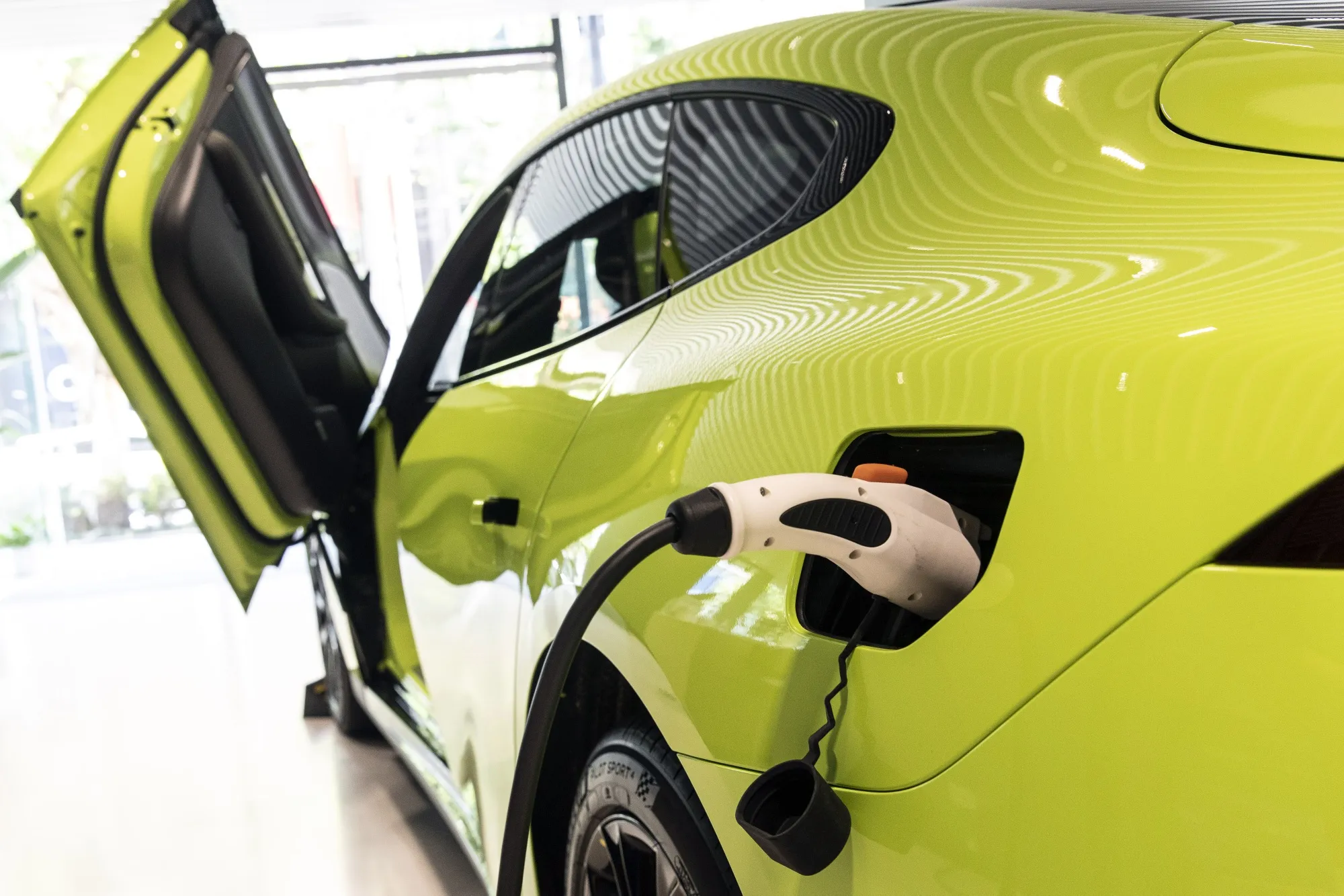 The XPeng P7 Wing Limited Edition electric vehicle being charged at a dealership in Shanghai, China.
