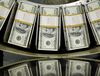 Stacks of one hundred dollar bills pass through a circulator machine at the Bureau of Engraving and Printing in Washington, D.C., U.S