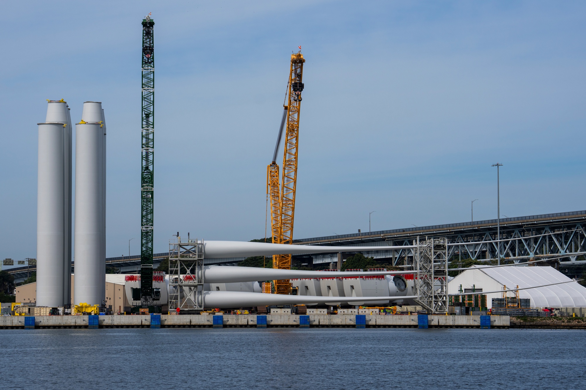 Wind turbine tower sections and blades at the Revolution Wind project assembly site at State Pier in New London, Connecticut, US, on Tuesday, Sept. 30, 2025. Orsted A/S will resume work on its nearly-completed wind farm off the coast of Rhode Island after a US judge ruled construction can continue during a lawsuit challenging the Trump administration's stop-work order, a major win for the beleaguered Danish energy giant.