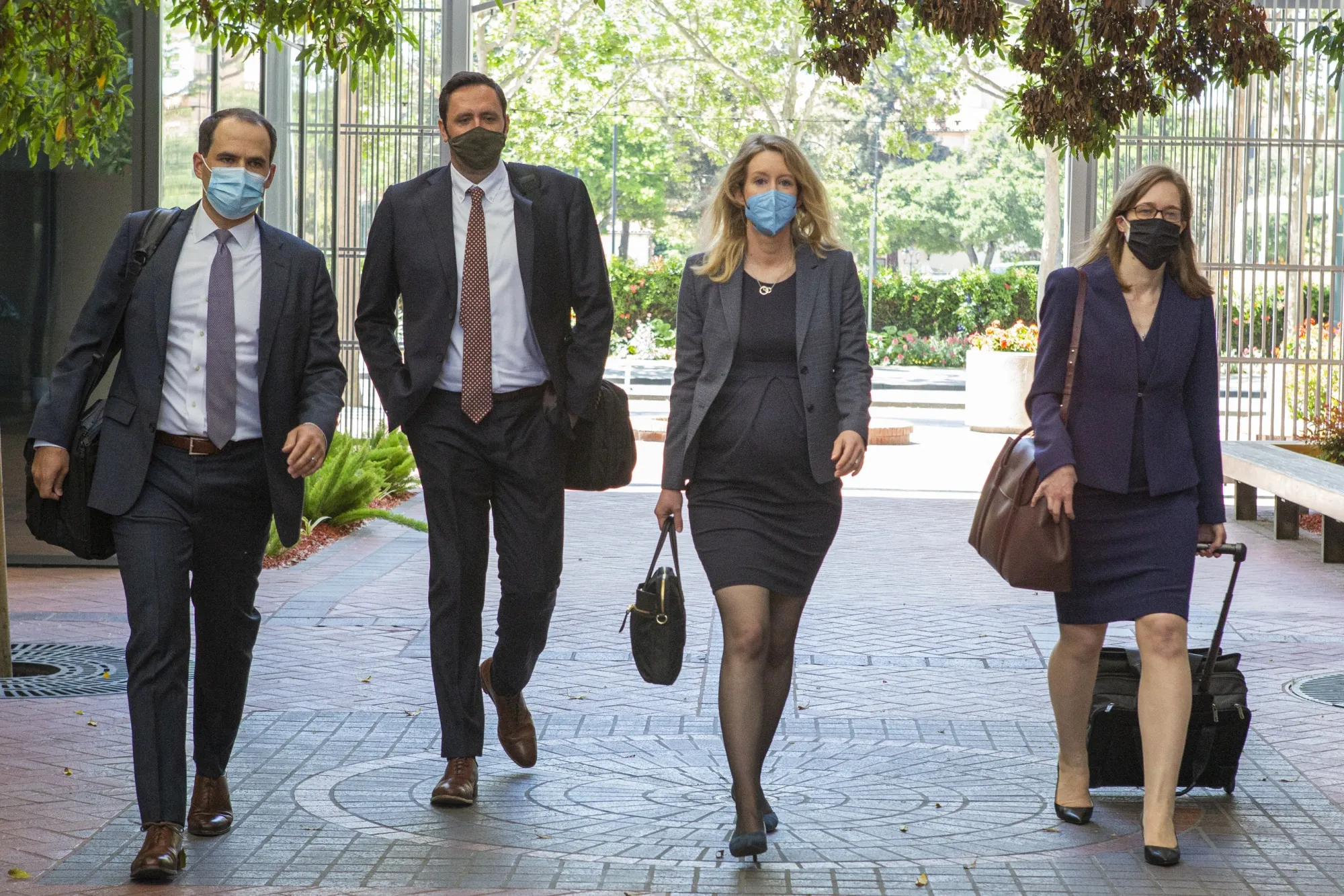 Elizabeth Holmes center right, arrives at U.S. federal court in San Jose, California, U.S., on May 6.