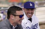 Los Angles Dodgers president of baseball operations Andrew Friedman, left, announces the arrival of free agent Freddie Freeman, right, Friday, March 18, 2022, in Glendale, Ariz. (AP Photo/Charlie Riedel)