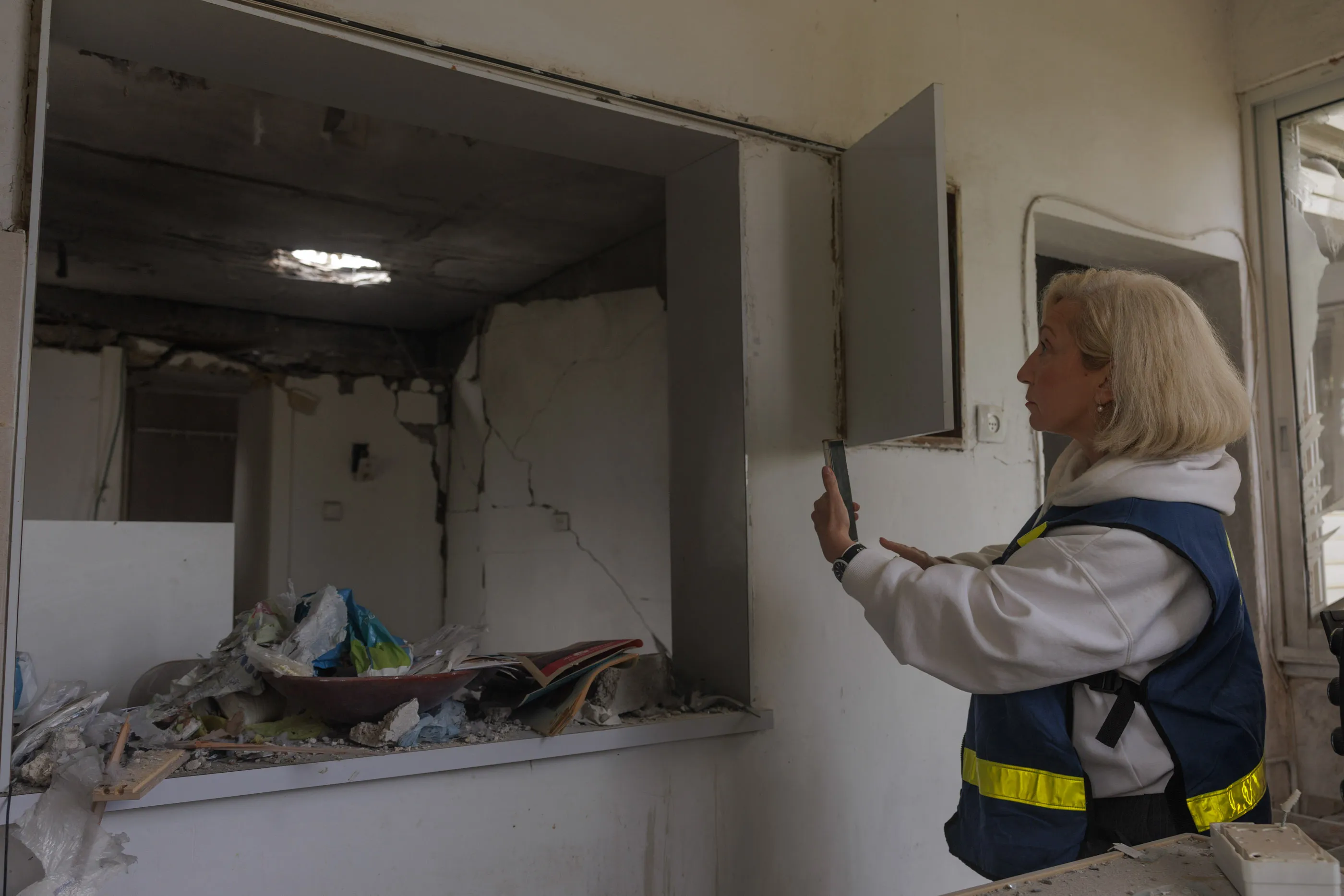 Janna Yehuda of Israel’s Property Tax Compensation Fund&nbsp;examines&nbsp;missile&nbsp;damage in&nbsp;Kiryat Ata near Haifa, Israel.