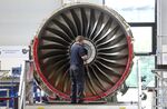 An employee works on a Trent 700 aircraft engine on the production line at the Rolls-Royce Holdings Plc factory in Derby.