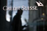 A pedestrian walks by a Credit Suisse Group AG bank branch in Geneva, Switzerland.