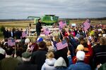 Supporters cheer as Republican presidential candidate Mitt Romney delivers remarks on the James Koch Farm in Van Meter, Iowa