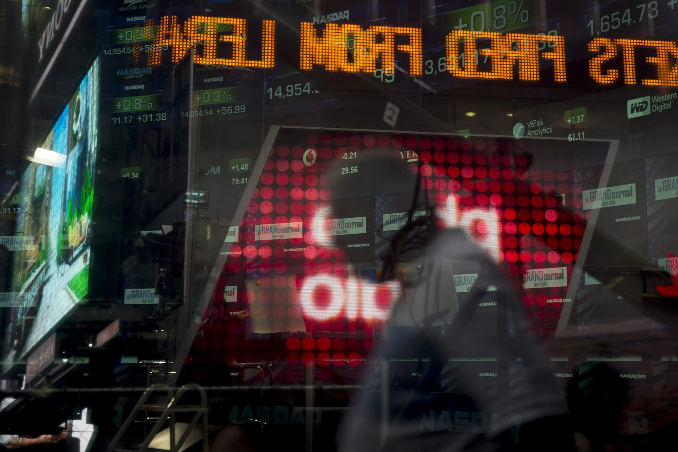 Pedestrians pass in front of the Nasdaq MarketSite in New York.
