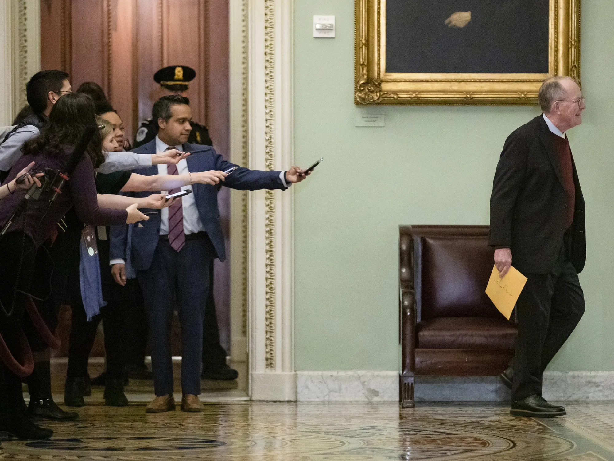 Reporters reach out to Senator Lamar Alexander during a recess in Washington,&nbsp;on Jan. 30.&nbsp;Alexander&nbsp;announced he’ll vote to block witnesses.