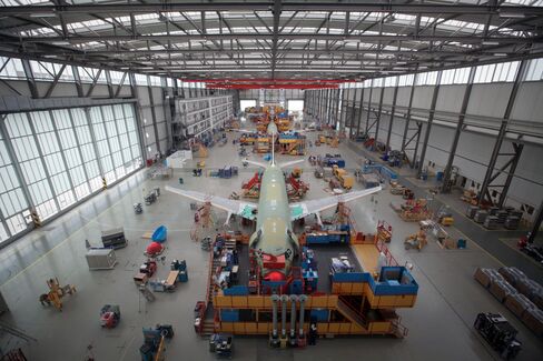A row of Airbus A320 aircraft stand on the production line at the company's factory in Hamburg.