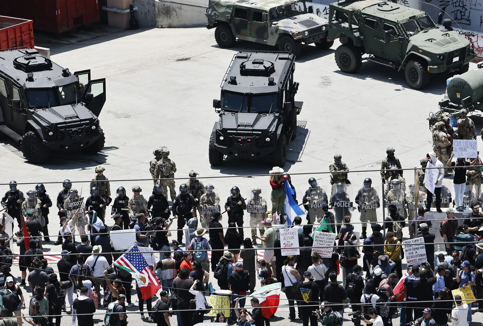 Protesters gather in front of California National Guard soldiers and LAPD officers guarding the Edward R. Roybal Federal building in Los Angeles, on June 10.
