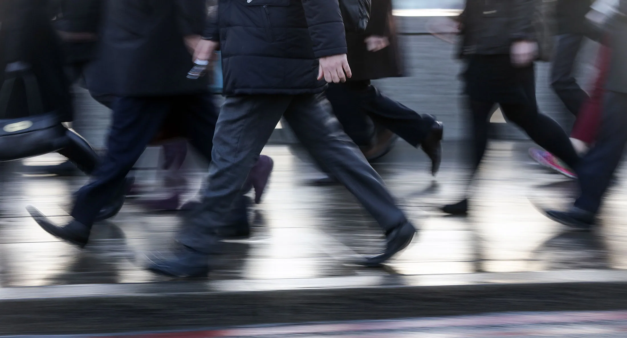Pedestrians walk across London Bridge towards the City of London financial district, U.K., on Monday, Jan. 4, 2016. U.K. stocks got no respite in the new year, after their worst annual drop since 2011, amid investor concern over a slowdown in China, the biggest consumer of commodities.
