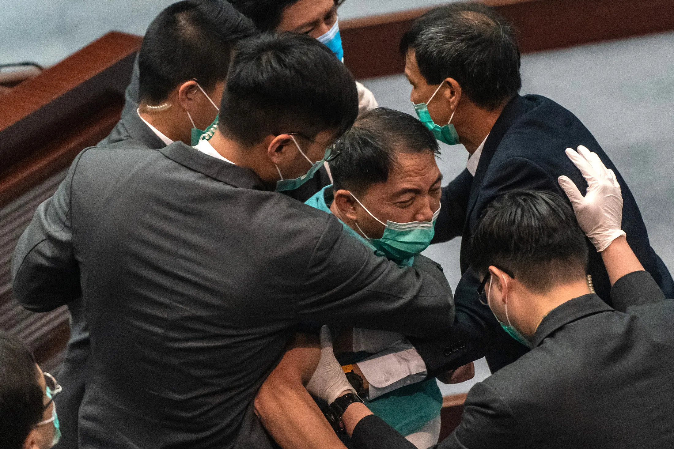 Wu Chi-wai, center, is removed by security during a scuffle at the Legislative Council earlier on May 22.