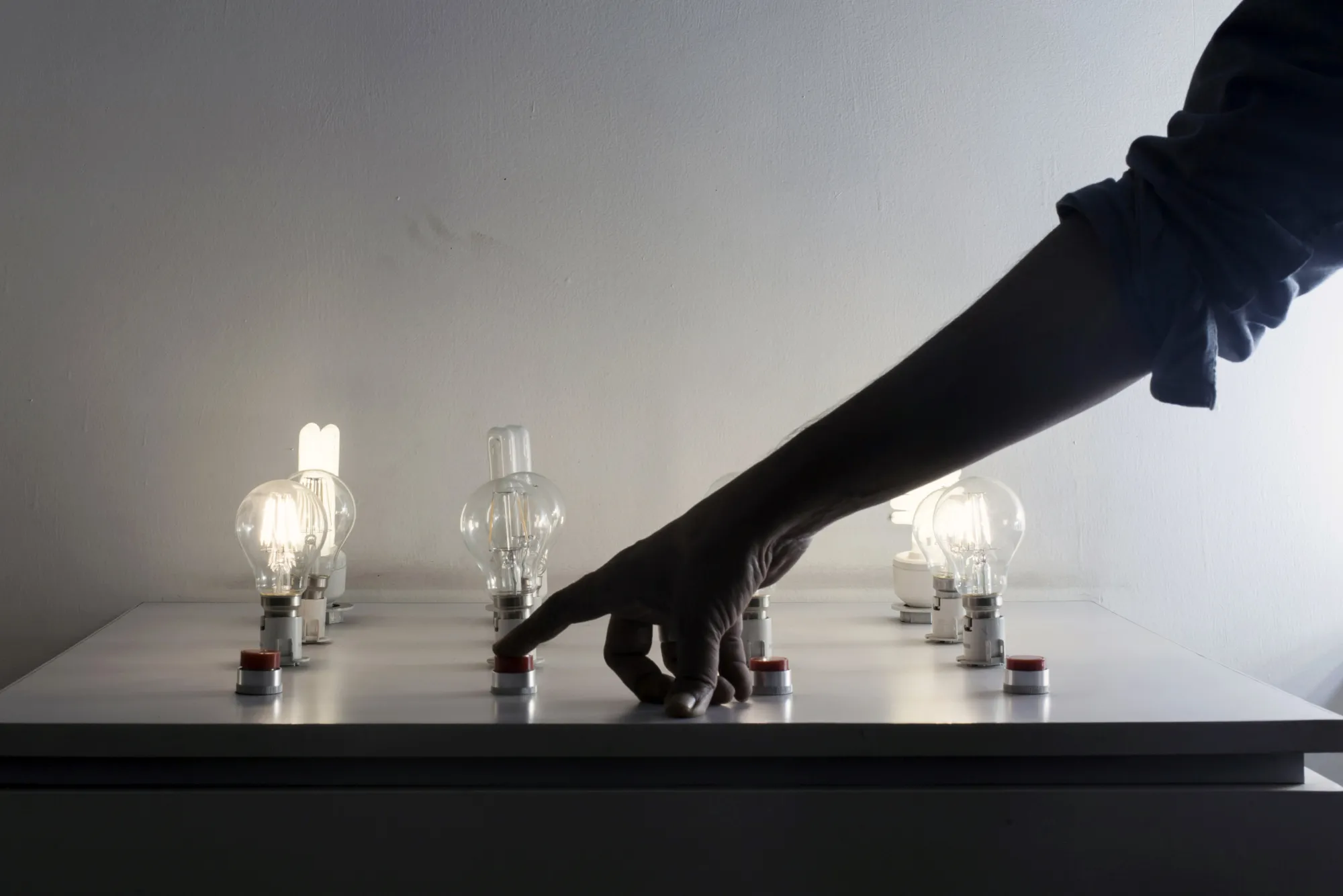 A worker demonstrates various LED light bulbs.