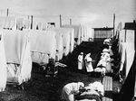 Nurses care for victims of a Spanish influenza epidemic outdoors amidst canvas tents during an outdoor fresh air cure, Lawrence, Massachusetts, 1918.