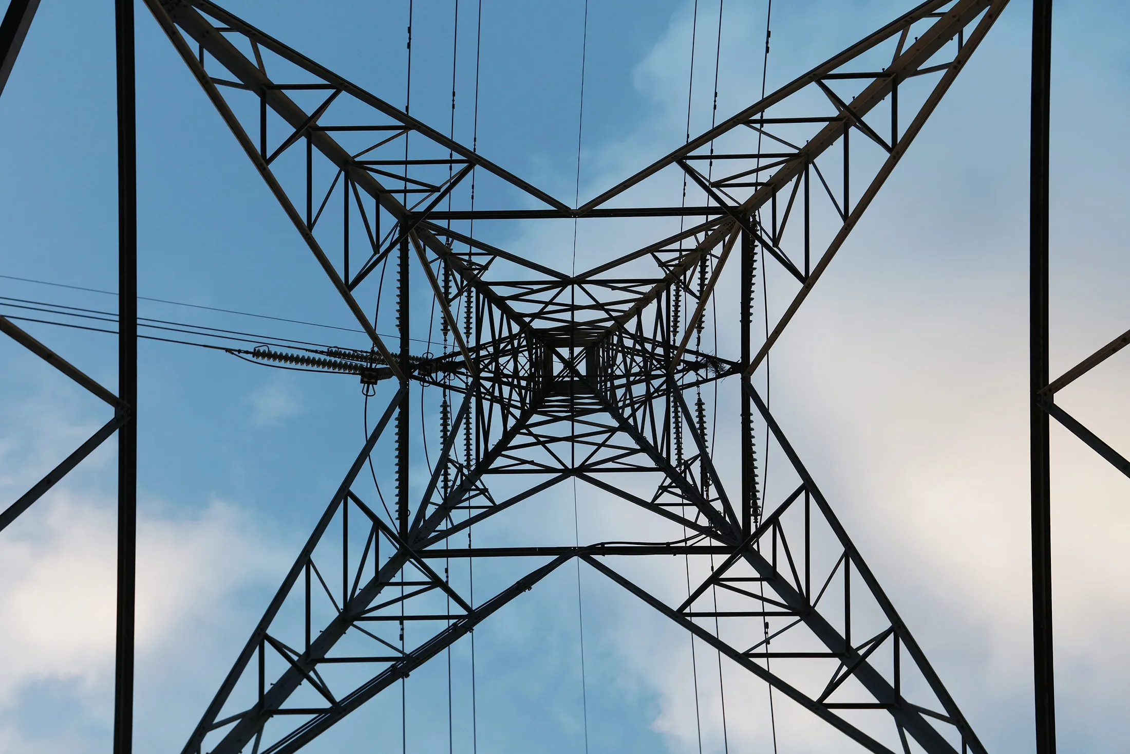 Power transmission lines hang from an electricity pylon near Uskmouth power station in Newport.
