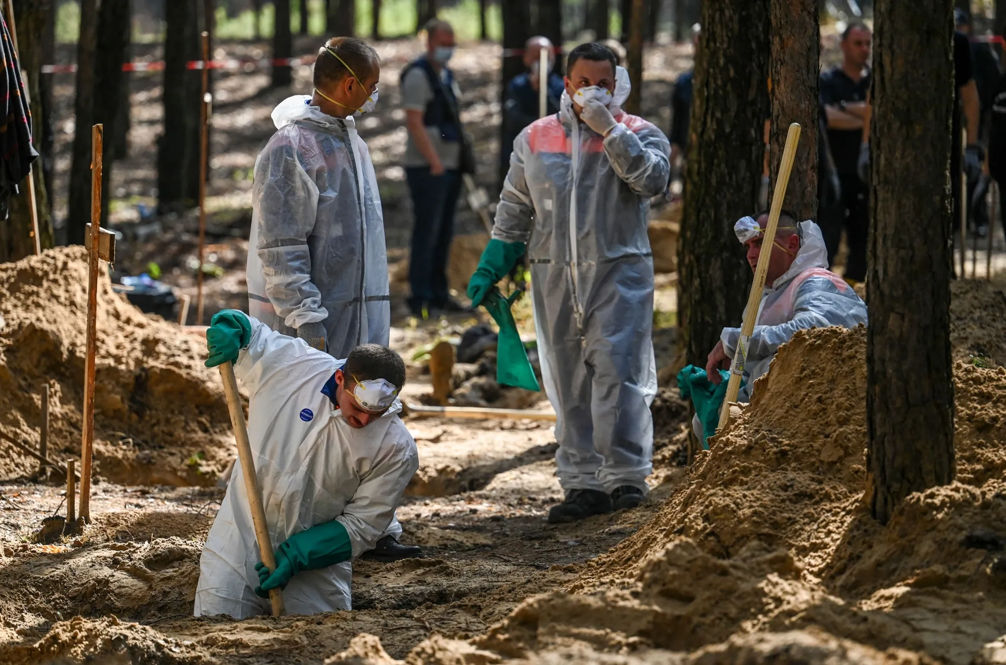 A forensics team works at&nbsp;the&nbsp;site of a mass grave near&nbsp;Izyum, Ukraine, in September.