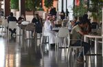 People sit at a cafe in a mall in the Saudi capital Riyadh on June 4.