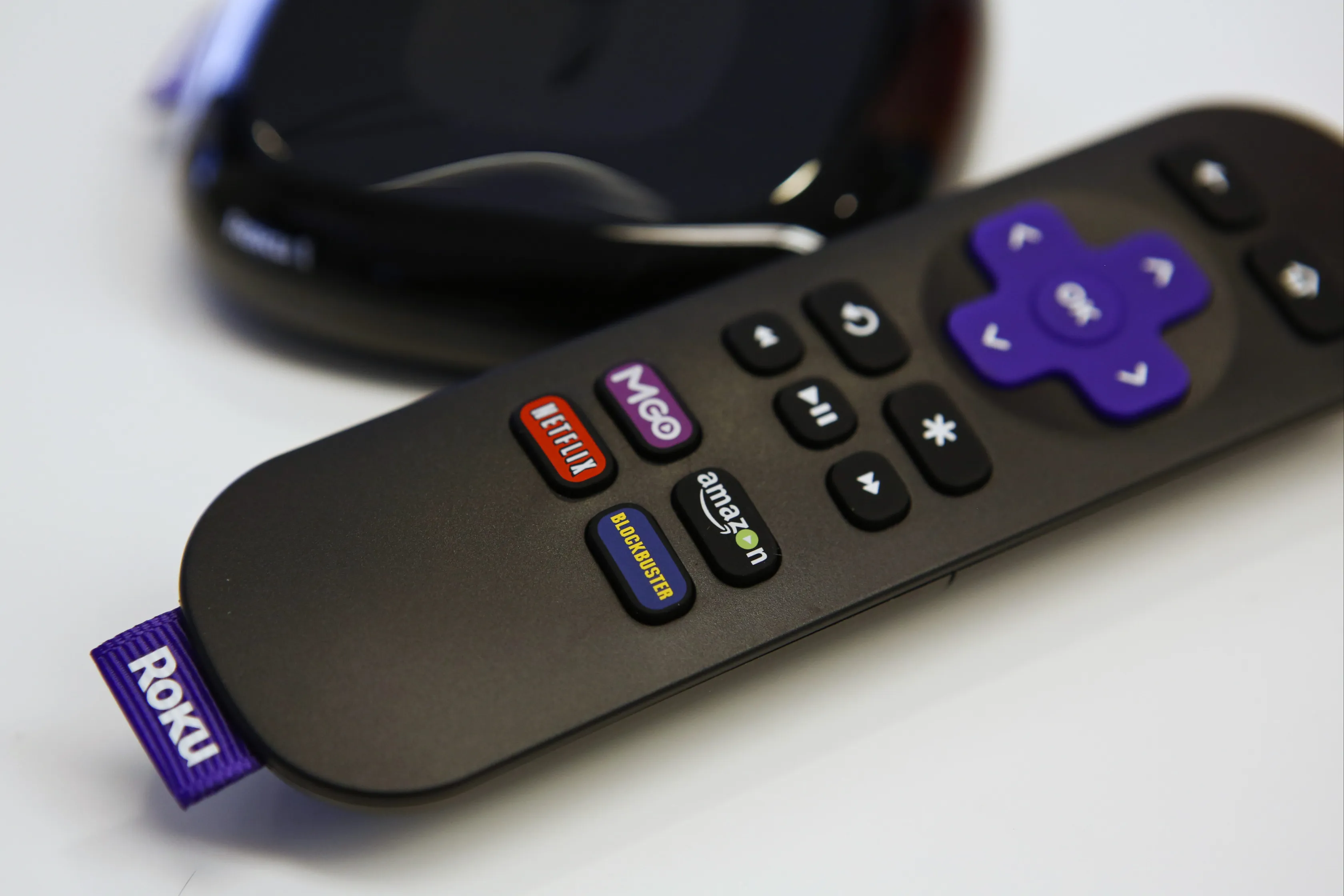 A Roku steaming player and remote control.