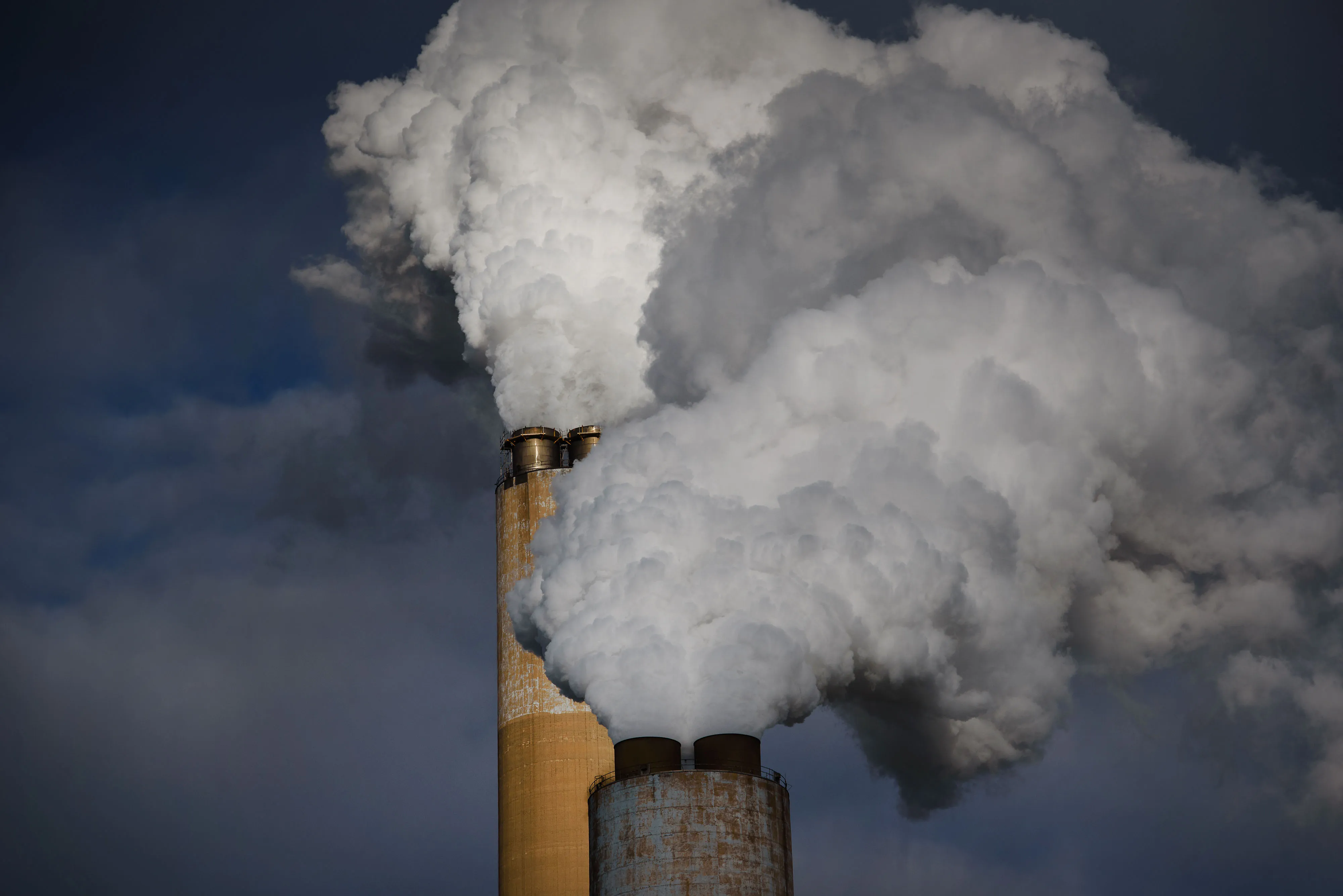 Steam billows out of the stacks of a&nbsp;coal-fired power plant.
