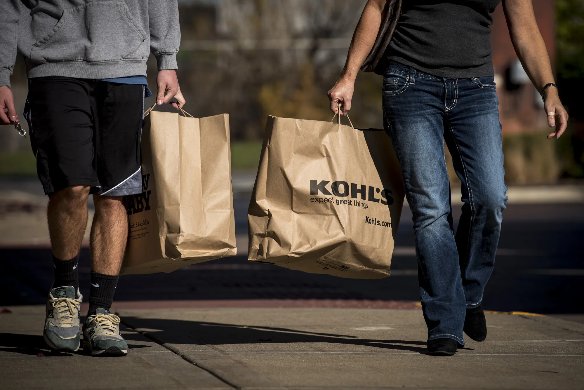 Shoppers carry Kohl's Corp. bags in Chicago, Illinois, U.S., on Sunday, Nov. 6, 2016.
