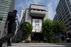 Pedestrians walk past the Tokyo Stock Exchange (TSE), operated by Japan Exchange Group Inc. (JPX), in Tokyo, Japan, on Tuesday, July 24, 2018.