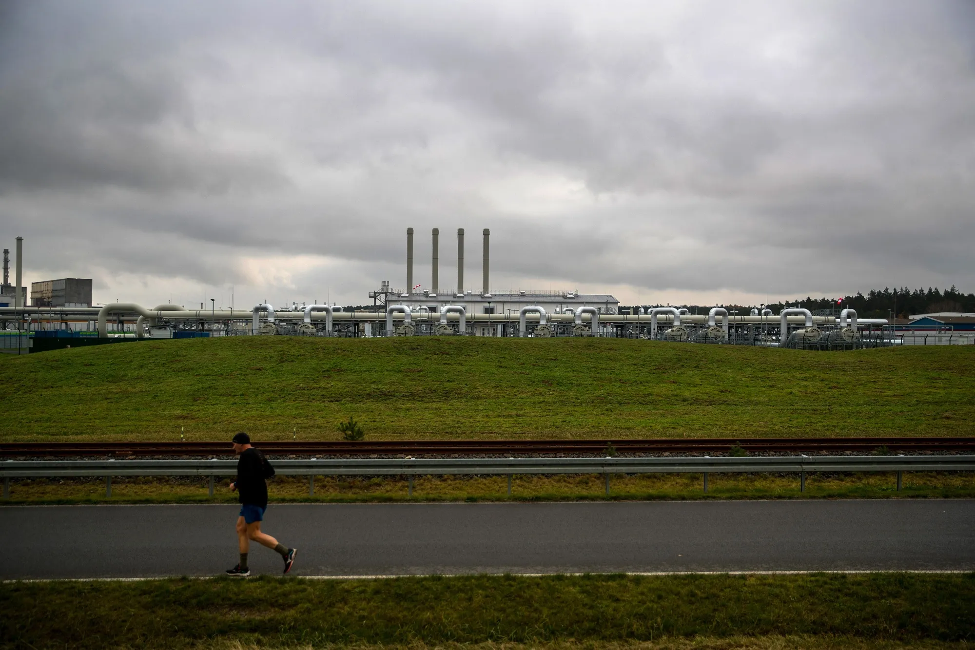 A jogger runs past the Nord Stream 2 gas receiving station in Lubmin, Germany, on&nbsp;Nov. 12, 2021. Germany halted approval of the&nbsp;pipeline because of the crisis in Ukraine.&nbsp;