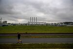 A jogger runs past the Nord Stream 2 gas receiving station in Lubmin, Germany, on Nov. 12, 2021. Germany halted approval of the pipeline because of the crisis in Ukraine. 
