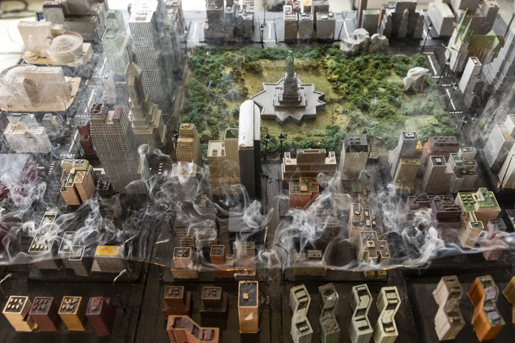 A power line glows and smokes in a diorama of a city used by Red Balloon Security to demonstrate vulnerabilities in the global electrical grid.