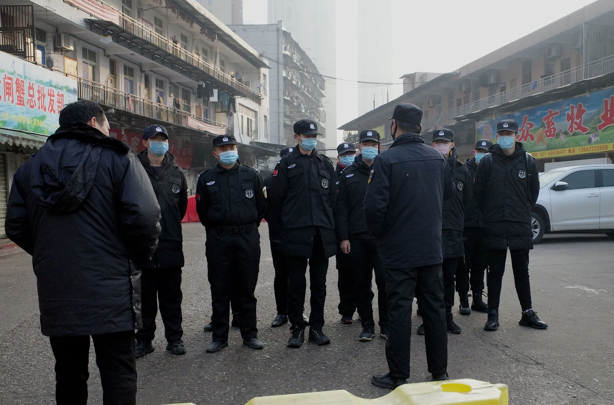 Security guards stand in front of the closed Huanan wholesale seafood market in Wuhan on Jan. 12.