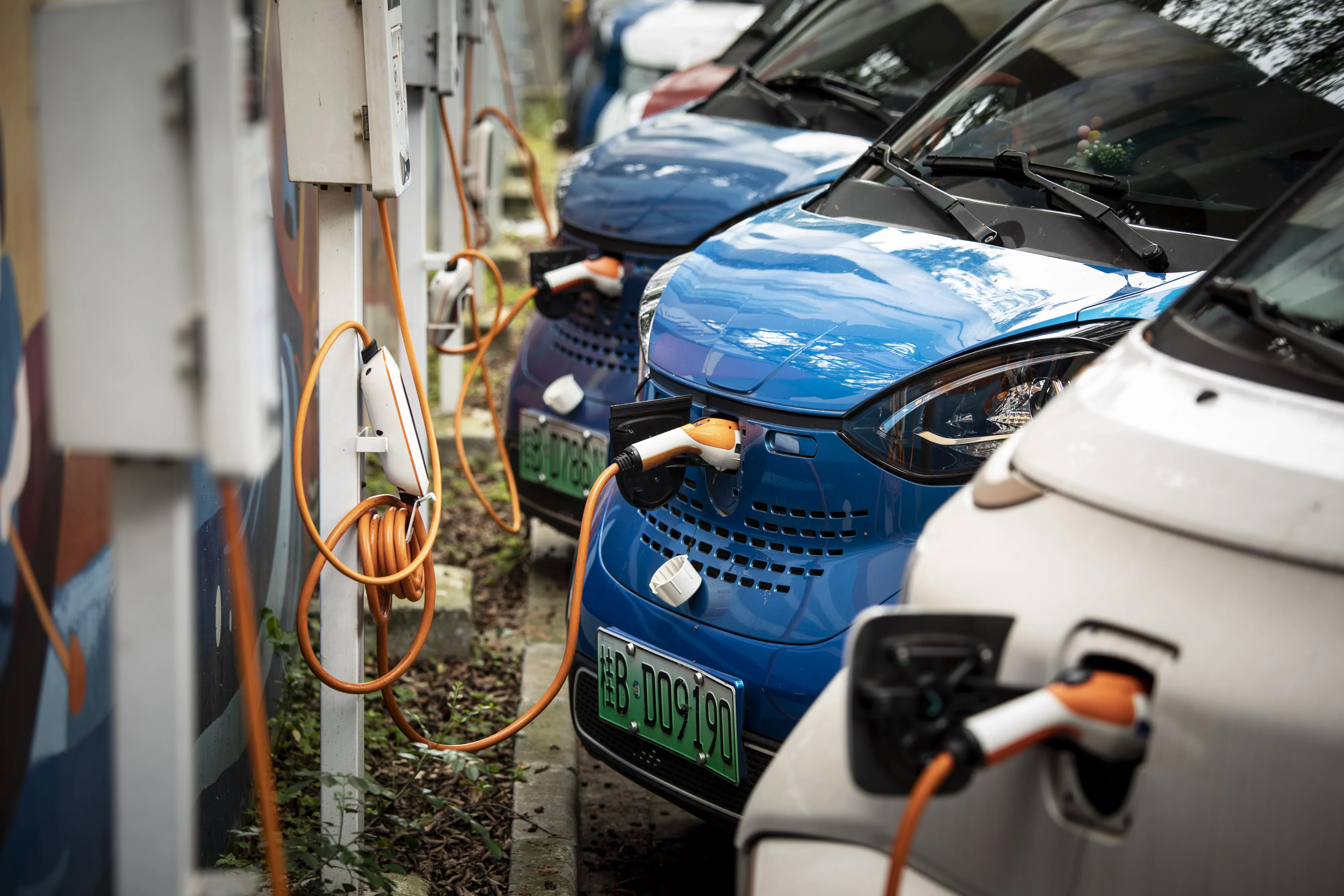 Electric vehicles charging in a parking lot in Liuzhou.