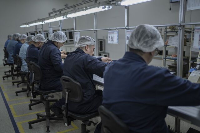 Workers assemble air conditioner parts at Electra/Aires del Sur factory in Rio Grande.