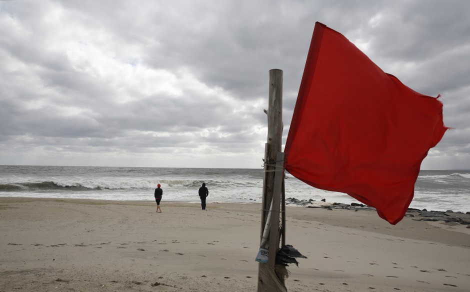 A red flag on the beach warns swimmers of high surf and dangerous currents in the Rockaways in October 2017, five years after the area was ravaged by Sandy.